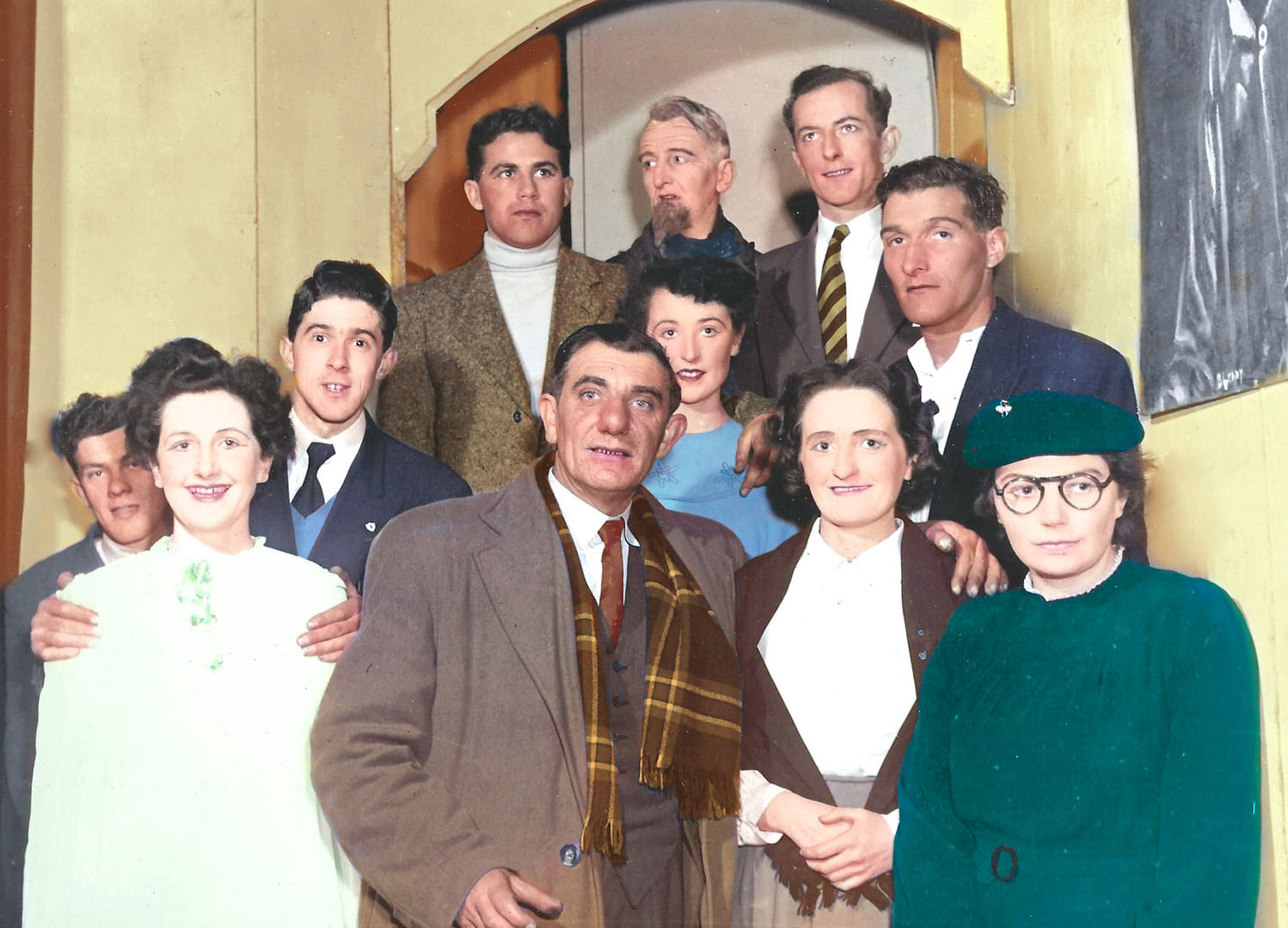 Photograph of Margie Murphy behind the mineral bar which she ran for decades in The Town Hall, Athenry.  She’s accompanied by Tom Fahy who also ran shops in the town including Fahy’s VG Foodmarket on Northgate Street.  Behind them are ads for Fox’s Glacier mints, Afton Cigarettes, Aspro, Cadbury’s Choffees, some Tayto Quips cards, posters for several showbands including the Athenry band Premier Aces. 