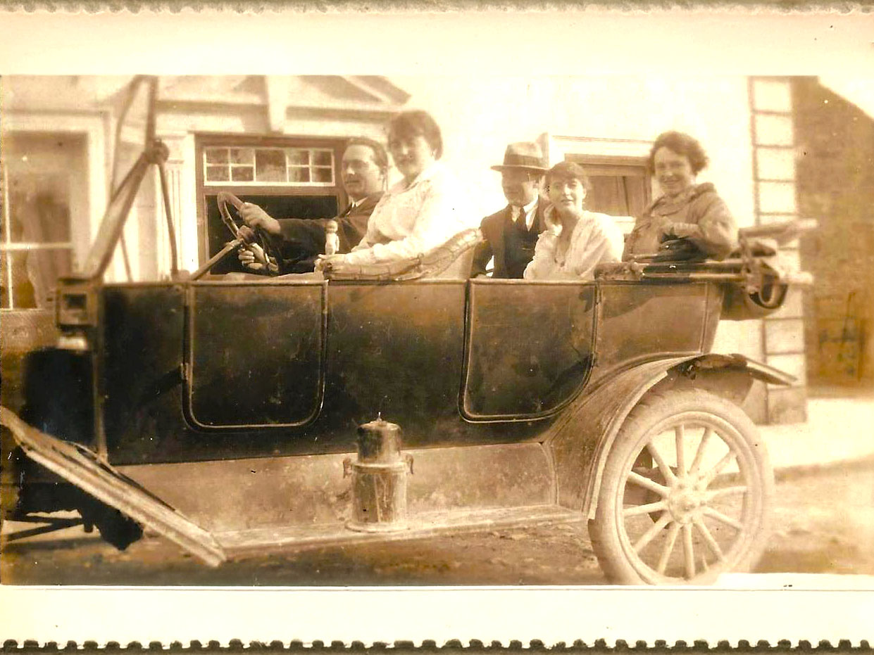 Photograph of Margie Murphy behind the mineral bar which she ran for decades in The Town Hall, Athenry.  She’s accompanied by Tom Fahy who also ran shops in the town including Fahy’s VG Foodmarket on Northgate Street.  Behind them are ads for Fox’s Glacier mints, Afton Cigarettes, Aspro, Cadbury’s Choffees, some Tayto Quips cards, posters for several showbands including the Athenry band Premier Aces. 